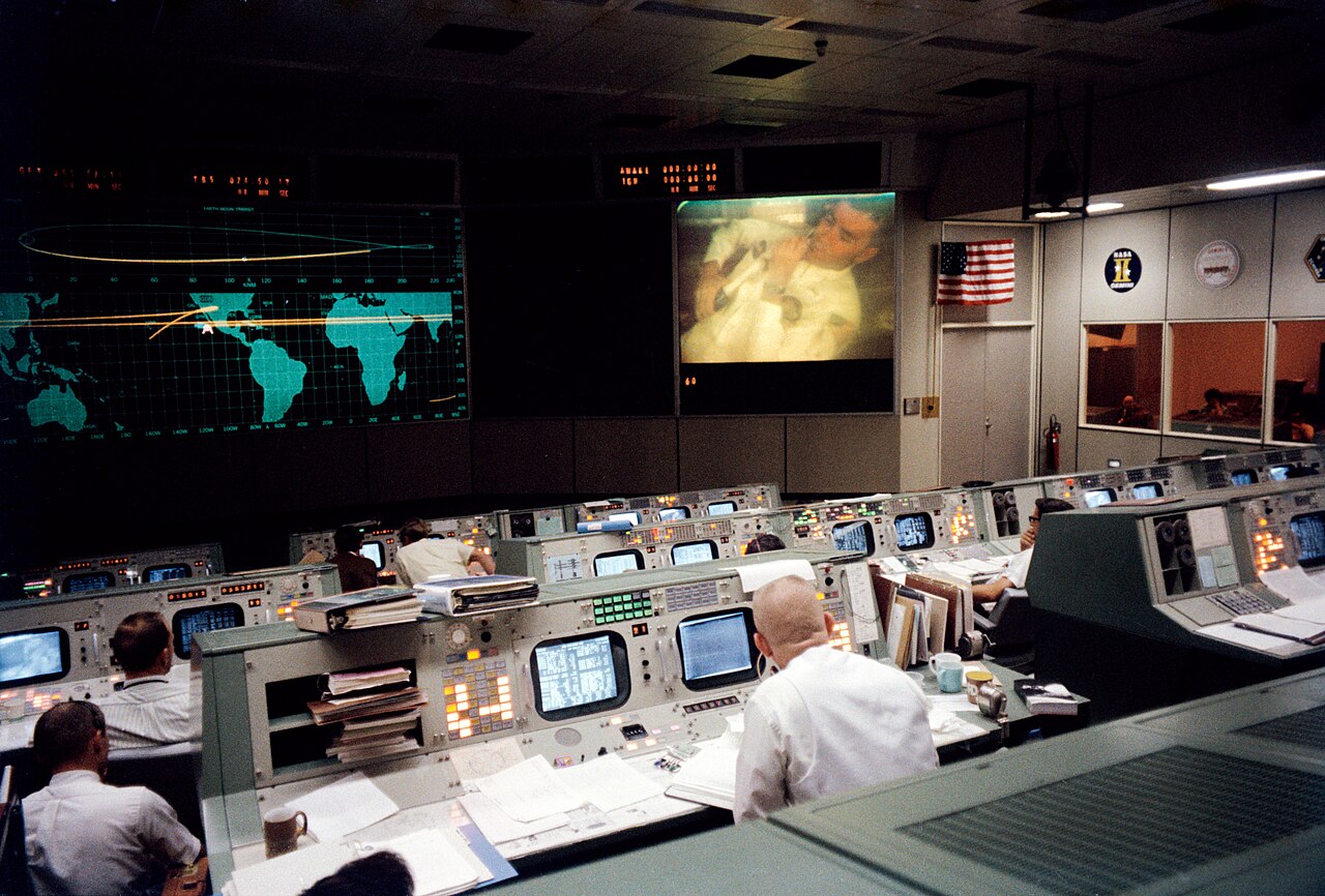 Apollo 13 photograph 4: NASA — Mission Operations Control Room during the Apollo 13 TV broadcast, moments before the accident. Flight controllers worked to bring the crew home. (NASA, public domain)