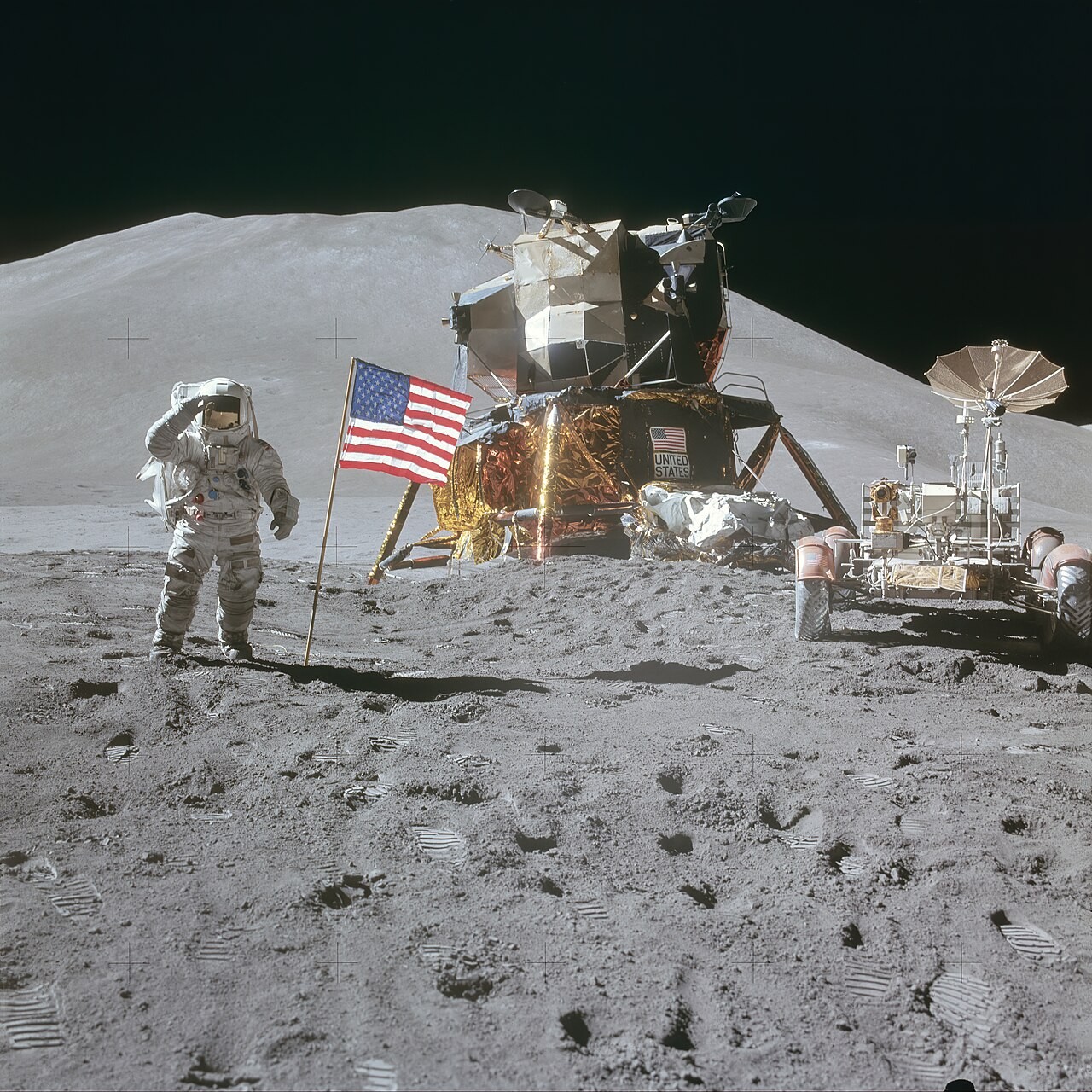 Apollo 15 photograph 1: NASA AS15-88-11866 — James Irwin, Lunar Rover, LM Falcon, Flag and Hadley Delta, Apollo 15, July 1971. (NASA, public domain)